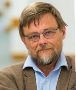 a man wearing glasses and smiling at the camera