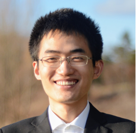 a man wearing a suit and tie smiling at the camera