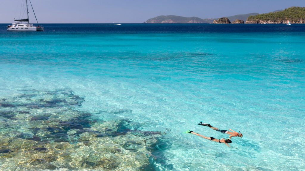 AI for Good - two snorkelers floating in a brilliant blue lagoon