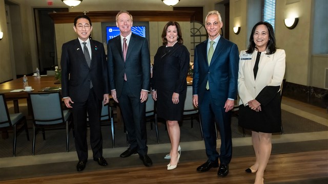 a man standing in front of Fumio Kishida, Brad Smith, Rahm Emanuel, Miki Tsusaka posing for the camera