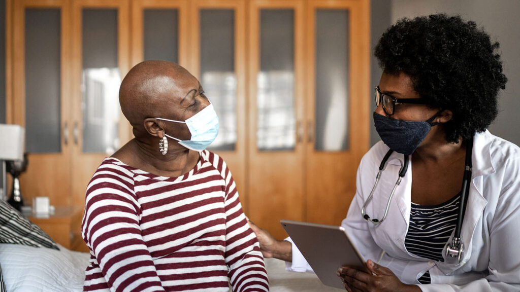 MSR Africa Lab - photo of two women, a doctor and a patient, talking and looking at a laptop computer