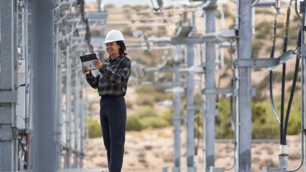 a person standing in front of a power plant