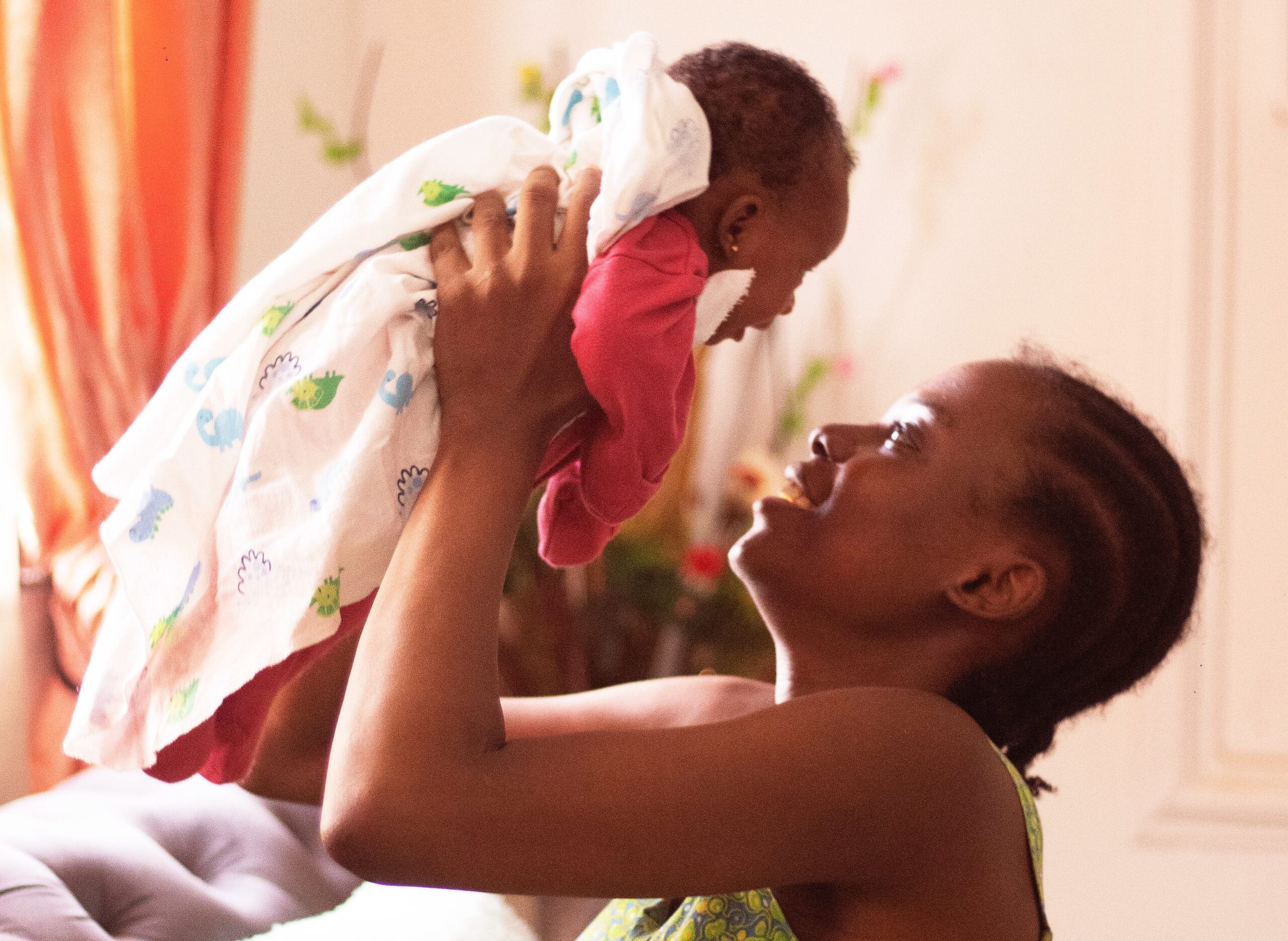 mother holding her baby in a blanket