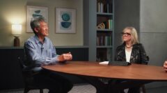 Peter Lee and Gretchen Huizinga sitting at a table having a discussion with Vijay Mital