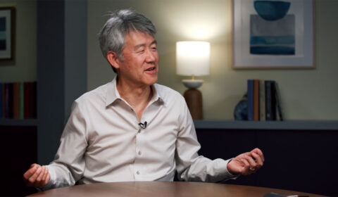 Peter Lee sitting at a table having a discussion with Vijay Mital and Gretchen Huizinga