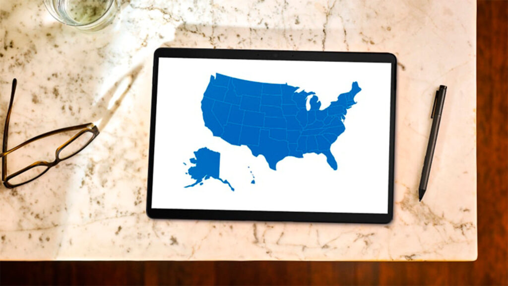 AI for Good - an overhead view of a marble tabletop with a tablet showing a state map of the USA