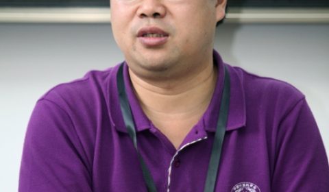 a man wearing a purple shirt