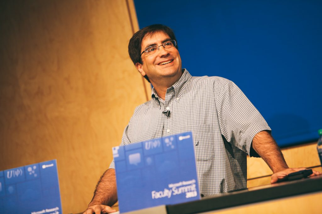 Eric Rudder, executive vice president of Microsoft’s Advanced Strategy and Research group, is shown speaking before introducing Bill Gates, Microsoft chairman, who delivered the opening keynote of Microsoft Research Faculty Summit 2013 on July 15.