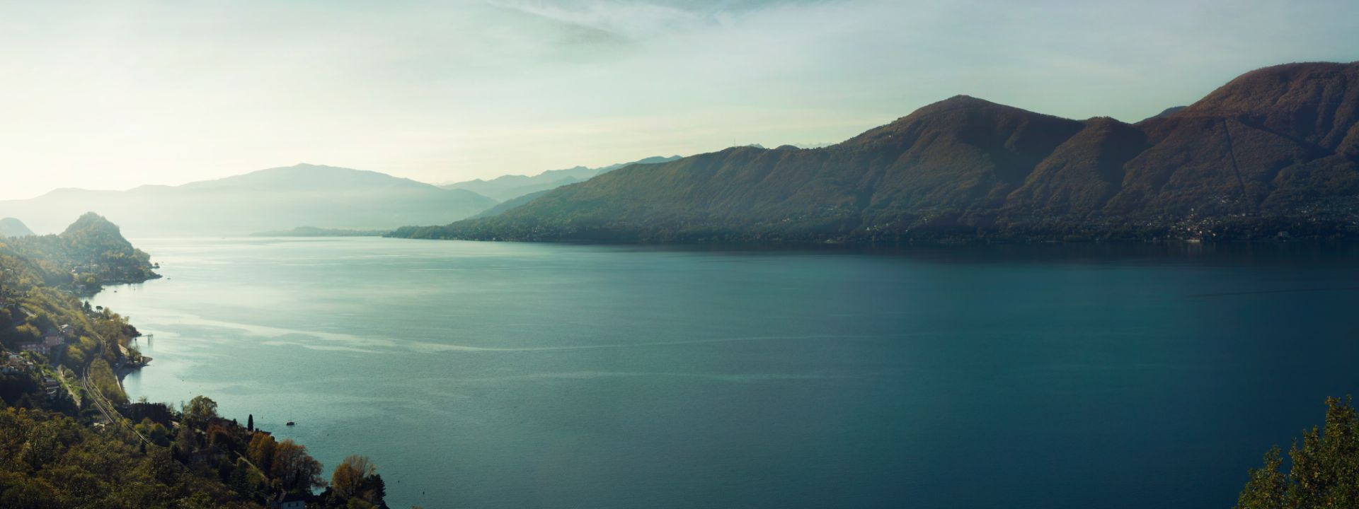 a large body of water with a mountain in the background