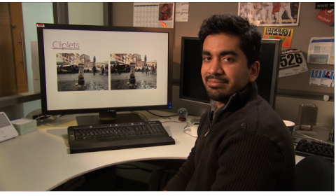 a man standing in front of a computer