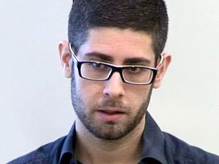 a man wearing glasses and looking at the camera