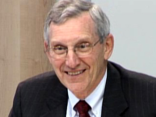 Don E. Detmer wearing a suit and tie smiling at the camera