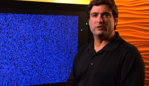 a man standing in front of a flat screen television