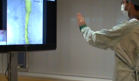 a man standing in front of a flat screen television