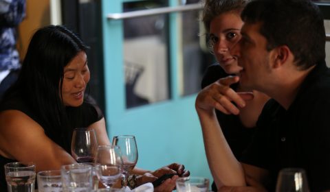 a group of people sitting at a table in a restaurant