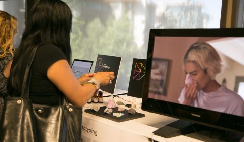 a woman standing in front of a laptop