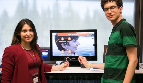 a man and a woman standing in front of a television