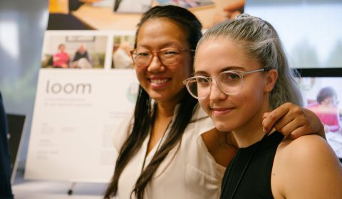 a man and a woman in glasses looking at the camera