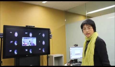 a person standing in front of a television