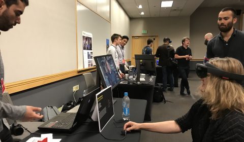 a group of people standing around a table