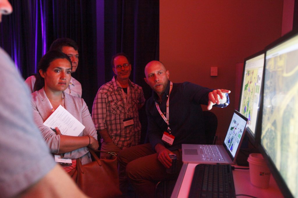 a group of people looking at a laptop