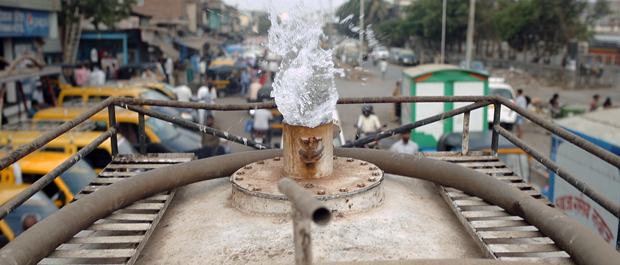 photo of water gushing out of a pipe