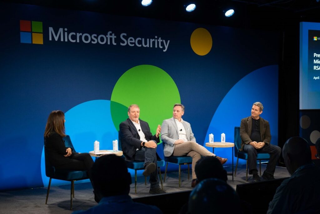 From left to right, Vasu Jakkal, Bret Arsenault, Any Elder, and Charlie Bell speaking at Pre-Day with Microsoft event.