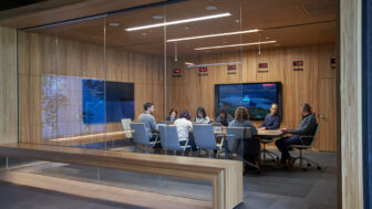 a conference room of people sitting around a table