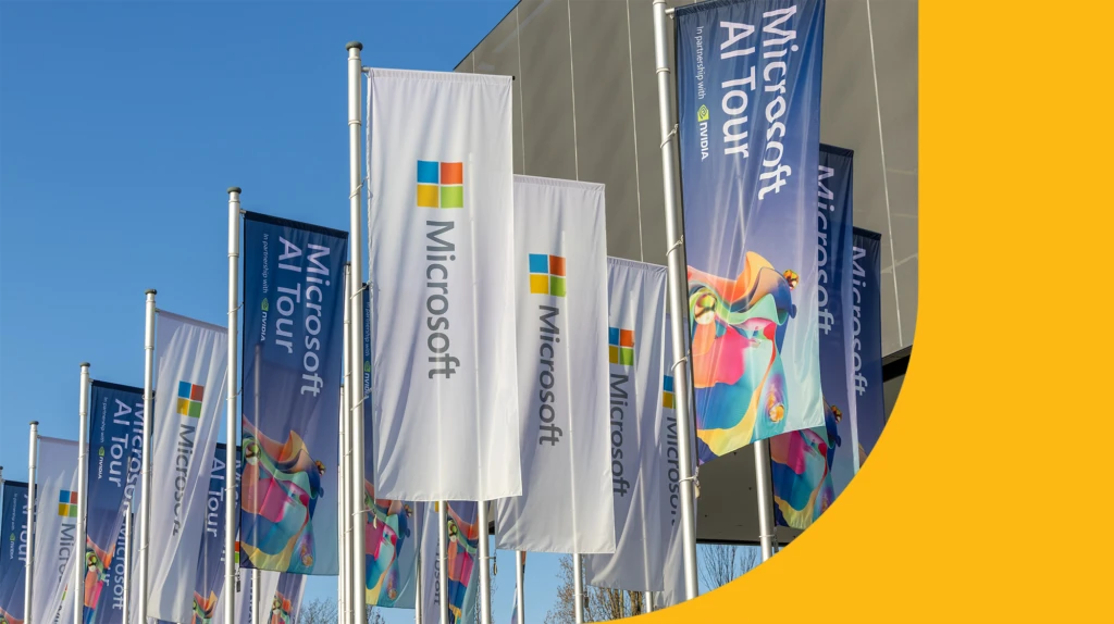 A group of flags advertising the Microsoft AI tour.