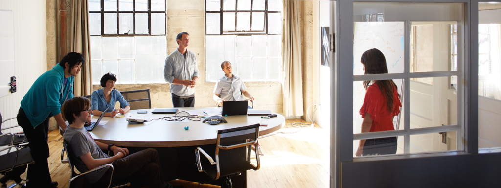 Image of four coworkers collaborating in an office.