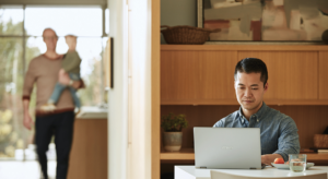 Image of a father working from home.