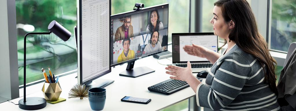 Image of a woman running a meeting from her desk.