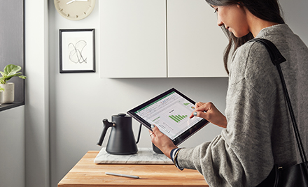 Image of a worker at home using a tablet.