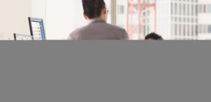 Two men sitting in an office working.