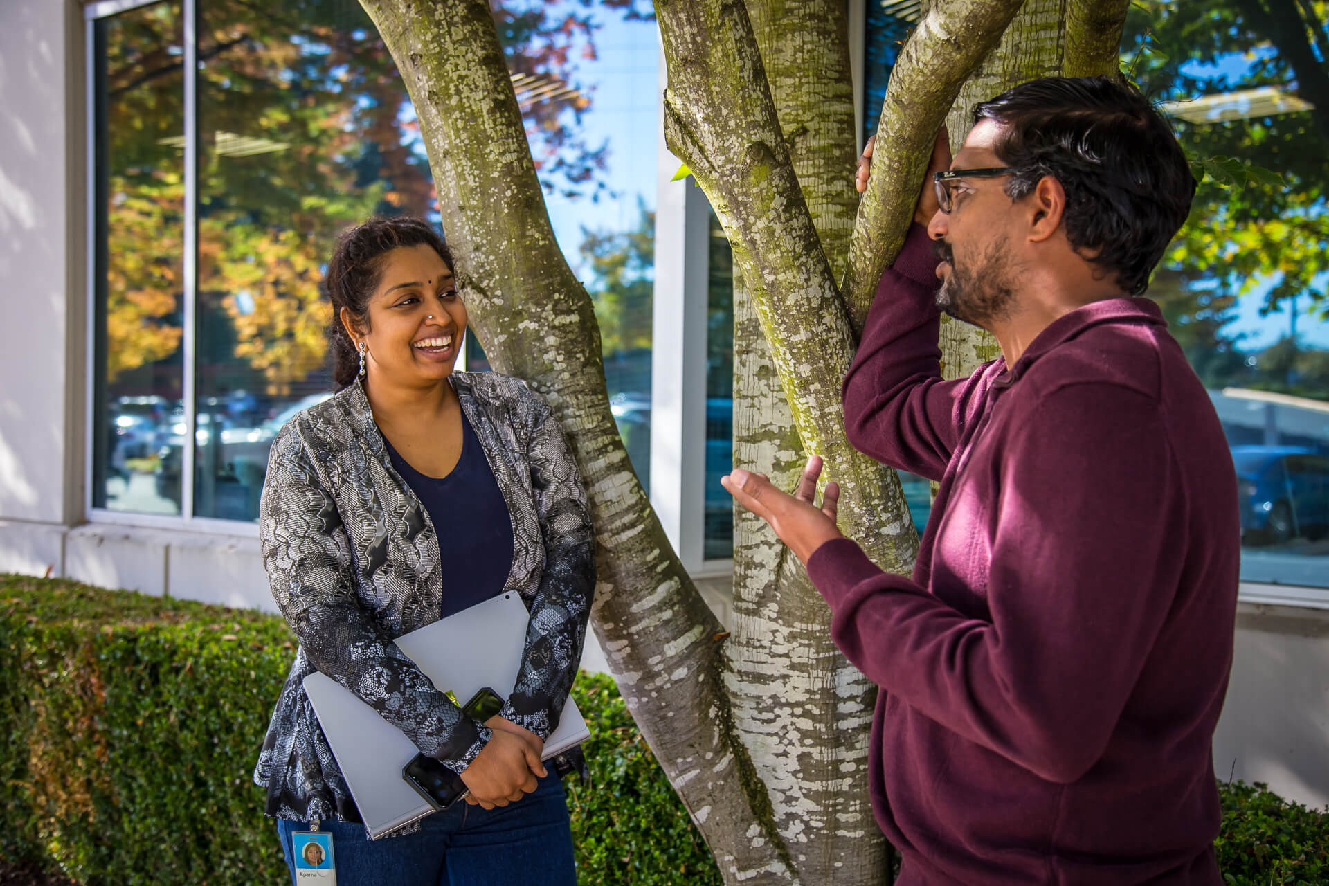 Aparna Chadalavada and Krishna Vemuri talk together outside of a building on the Microsoft campus.