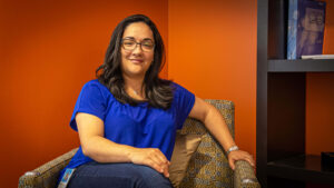 Vazjier Rosario looks at the camera while sitting on a couch in an open area near her office on the Microsoft campus.