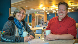 Hans Reutter and Elke Bregler sit together and smile at the camera.