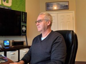 Dale Voth works on his laptop in his home office. 