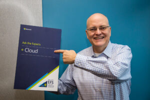 Apple poses for a photo holding a “cloud expert” placard.