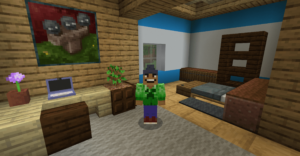 A Minecraft character smiles at the camera. She’s standing next to a desk with an open laptop.