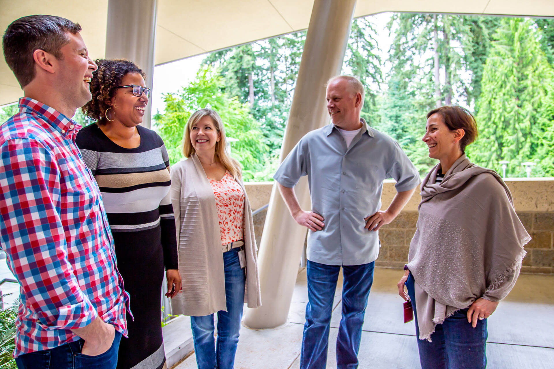 Bill Lincoln, Cassandra Young, Rebekah Hankins, Kurt Hughes, and Liz Friedman share a laugh in a photo taken outside.