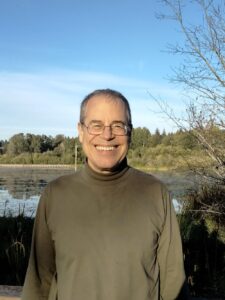 Willingham smiles for a photo in front of a pond of water.