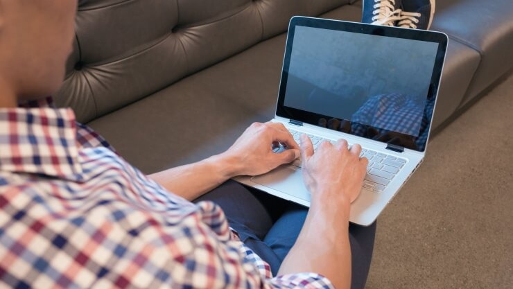 Businessman in office building with laptop.