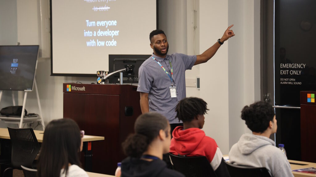 Akinyemi speaks to students in a classroom setting.