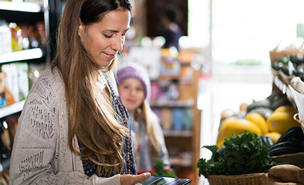 Image of a woman scrolling on her phone.