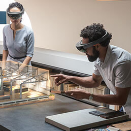 A man and a woman using Microsoft HoloLens