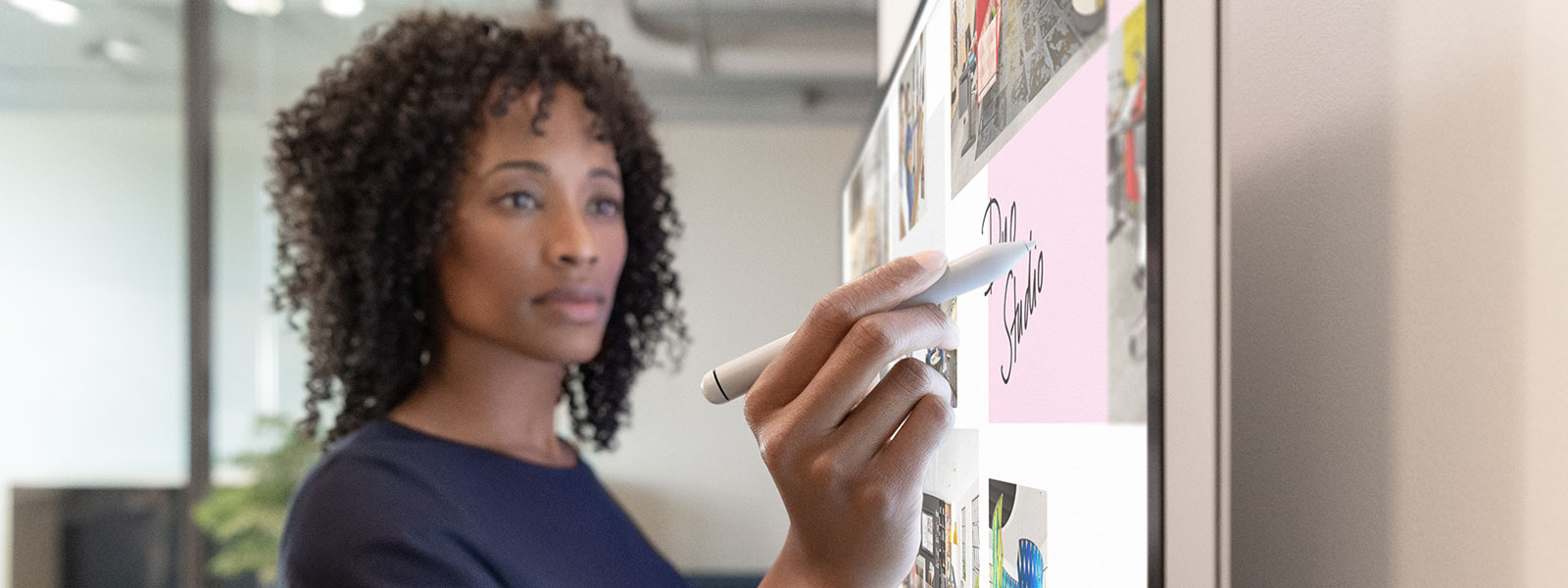 Woman executive working on Surface Hub 2S in Whiteboard with Surface Hub 2 Pen 