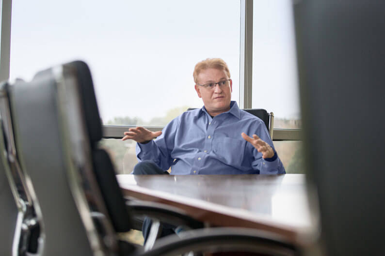 Man talking in conference room while seated