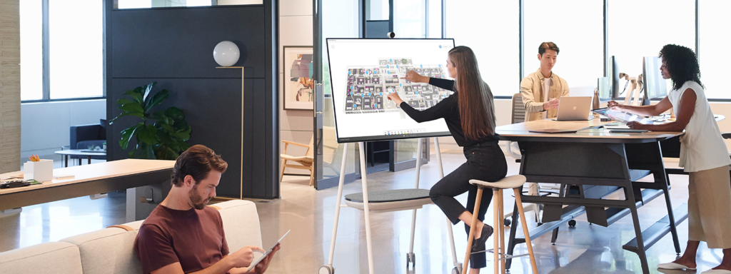 Image of four workers collaborating in a lounge.