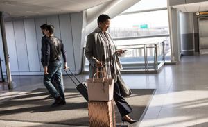 Image of an enterprise female in business travel at airport.